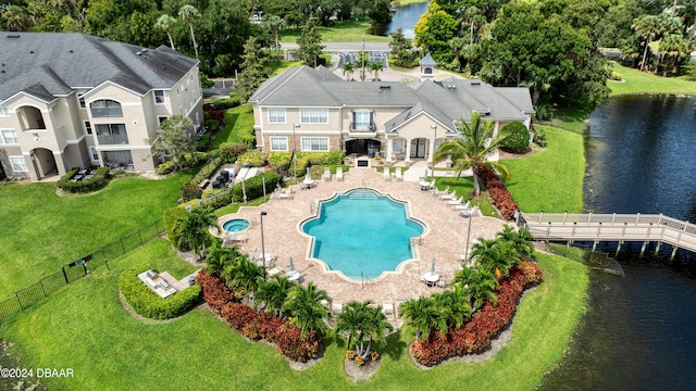 view of pool featuring a lawn, a patio, and a water view