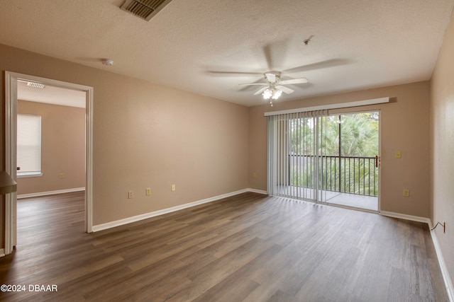 unfurnished room featuring a textured ceiling, dark wood-type flooring, and ceiling fan