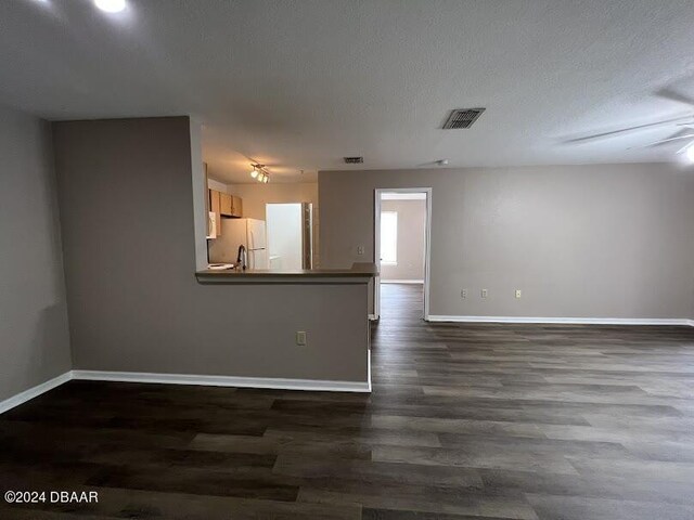940 Village Trl Unit 2-207, Port Orange, FL 32127 - unfurnished room with baseboards and dark wood-style flooring