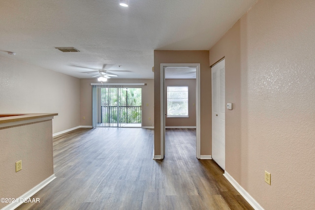 unfurnished living room featuring hardwood / wood-style flooring and ceiling fan