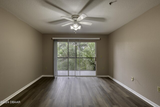 940 Village Trl Unit 2-207, Port Orange, FL 32127 - empty room with dark wood finished floors, a ceiling fan, baseboards, and a textured ceiling
