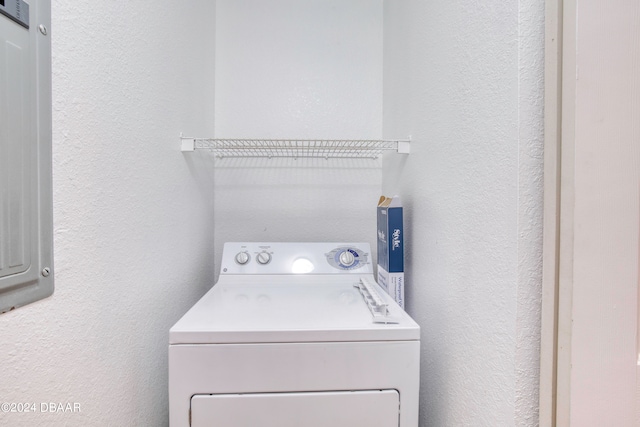 laundry area featuring electric panel and washer / dryer