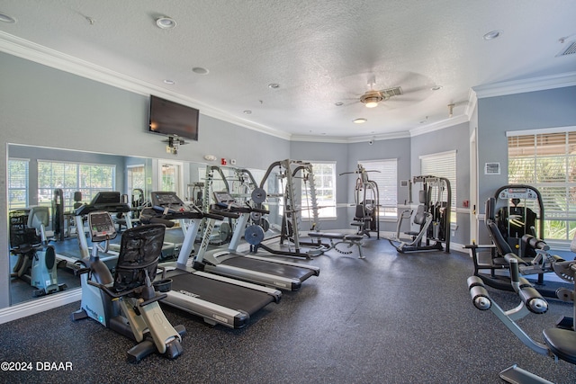 workout area featuring ceiling fan, a textured ceiling, and ornamental molding