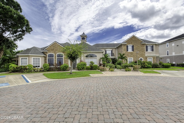 940 Village Trl Unit 2-207, Port Orange, FL 32127 - view of front of home with uncovered parking and stone siding