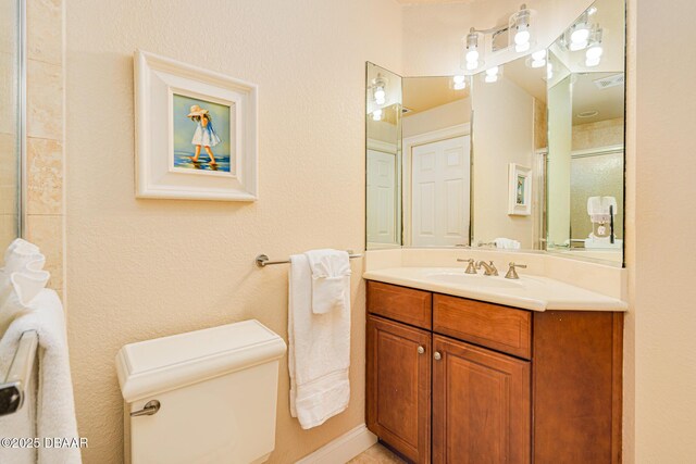 4427 S Atlantic Ave, Ponce Inlet, FL 32127 - bathroom with toilet, a shower with door, and vanity