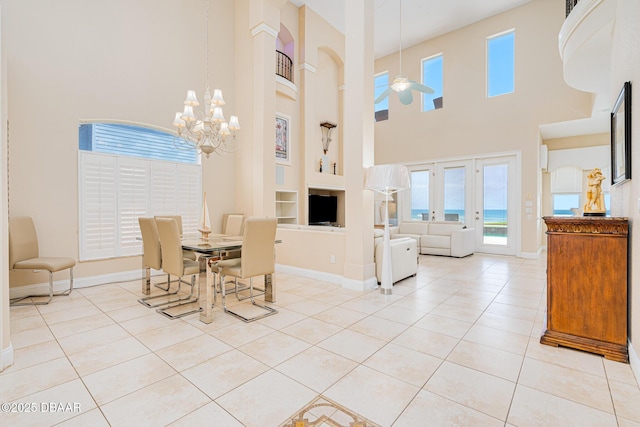 4427 S Atlantic Ave, Ponce Inlet, FL 32127 - dining room with a high ceiling, built in shelves, light tile patterned flooring, baseboards, and a chandelier