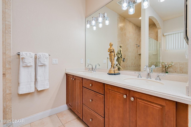 4427 S Atlantic Ave, Ponce Inlet, FL 32127 - bathroom with tile patterned flooring, double vanity, baseboards, and tiled shower