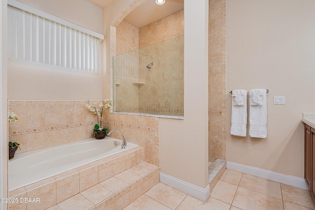 4427 S Atlantic Ave, Ponce Inlet, FL 32127 - full bath with tile patterned flooring, a walk in shower, a bath, vanity, and baseboards