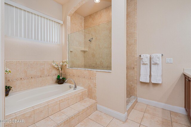 4427 S Atlantic Ave, Ponce Inlet, FL 32127 - full bath with tile patterned flooring, a walk in shower, a bath, vanity, and baseboards