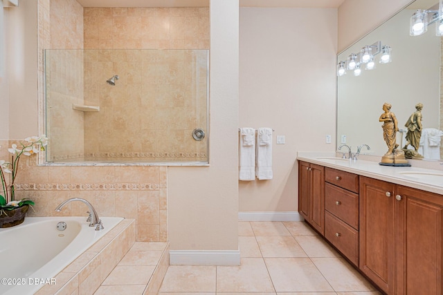 4427 S Atlantic Ave, Ponce Inlet, FL 32127 - bathroom with tile patterned floors, a garden tub, double vanity, baseboards, and a walk in shower
