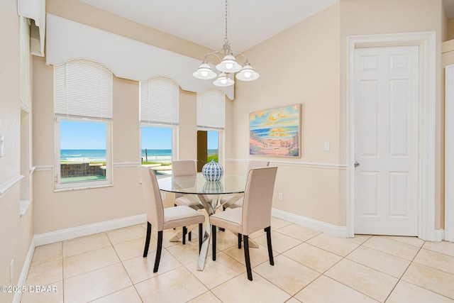 4427 S Atlantic Ave, Ponce Inlet, FL 32127 - dining room with a chandelier, a water view, light tile patterned floors, and baseboards