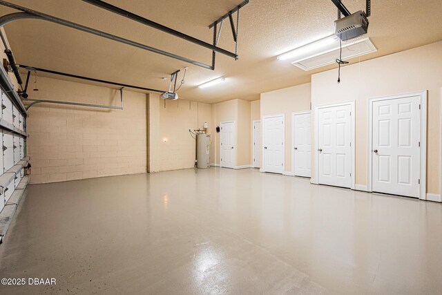 4427 S Atlantic Ave, Ponce Inlet, FL 32127 - garage with water heater, a garage door opener, and concrete block wall