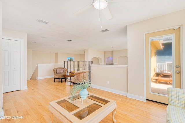4427 S Atlantic Ave, Ponce Inlet, FL 32127 - living area featuring light wood-type flooring, baseboards, ceiling fan, and an upstairs landing