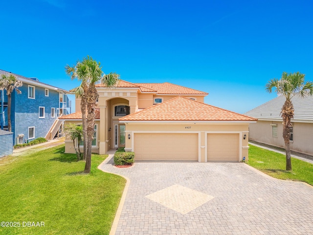 4427 S Atlantic Ave, Ponce Inlet, FL 32127 - mediterranean / spanish house with stucco siding, an attached garage, decorative driveway, a front yard, and a tile roof