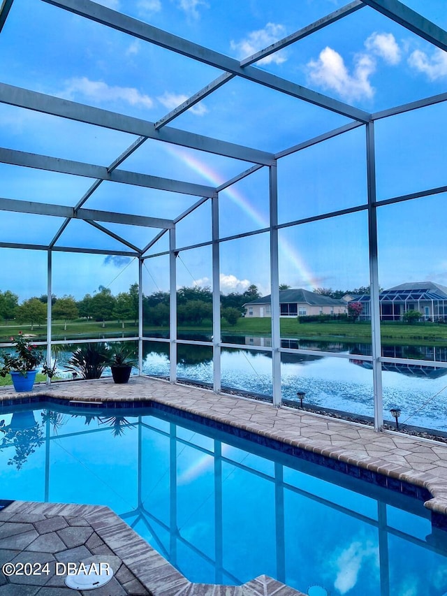 view of pool featuring a lanai and a water view