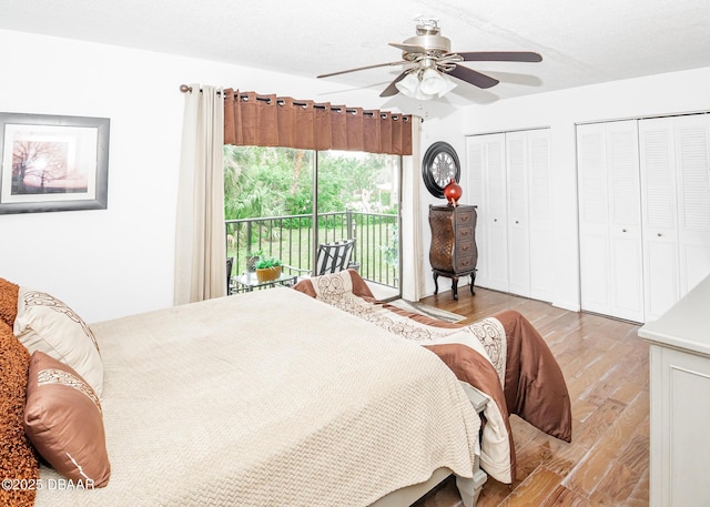 bedroom with ceiling fan, a textured ceiling, access to outside, multiple closets, and light wood-type flooring