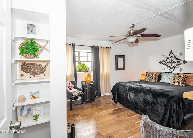 bedroom featuring light hardwood / wood-style floors and a textured ceiling