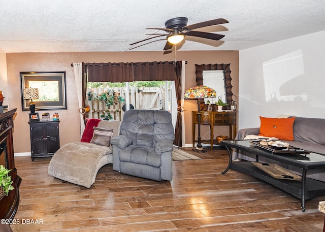 living room with hardwood / wood-style floors, a textured ceiling, and ceiling fan