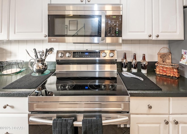 kitchen featuring tasteful backsplash, stainless steel appliances, and white cabinets