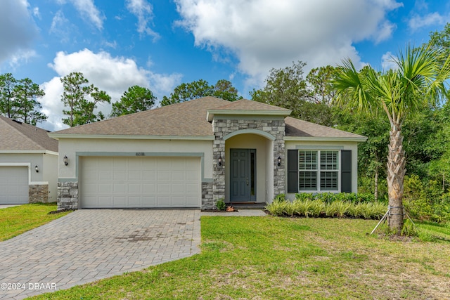 view of front facade with a garage and a front lawn