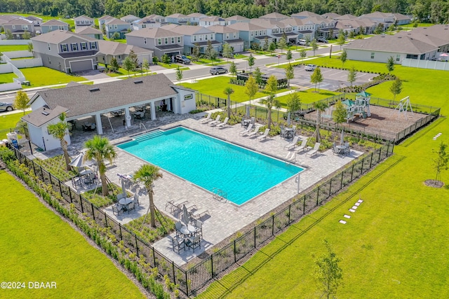 view of pool featuring a patio and a lawn