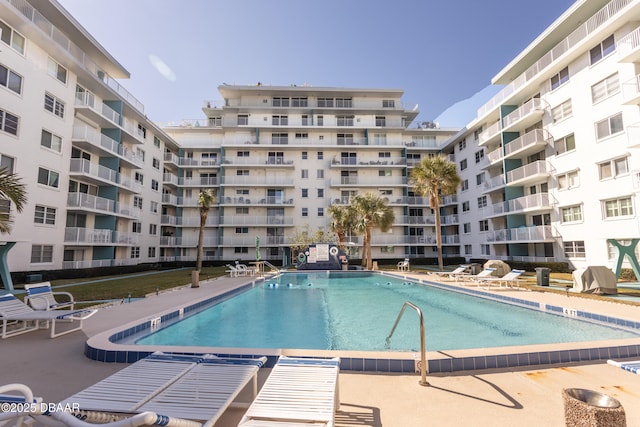 view of pool with grilling area and a patio