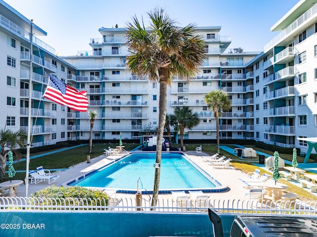 view of pool featuring a patio and fence