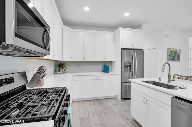 802 Margaritaville Ave, Daytona Beach, FL 32124 - kitchen featuring appliances with stainless steel finishes, a sink, light countertops, white cabinetry, and recessed lighting