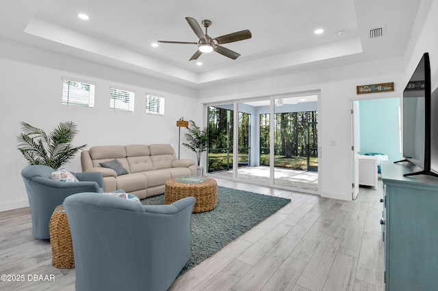 802 Margaritaville Ave, Daytona Beach, FL 32124 - living room with a tray ceiling, ceiling fan, light wood finished floors, baseboards, and recessed lighting