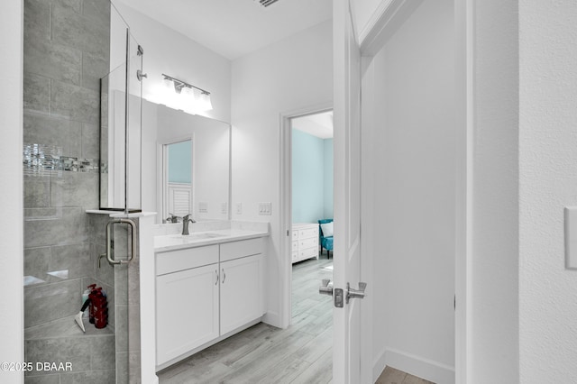 802 Margaritaville Ave, Daytona Beach, FL 32124 - bathroom featuring a stall shower, vanity, wood finished floors, and ensuite bath