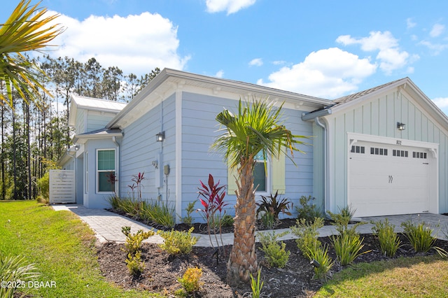 802 Margaritaville Ave, Daytona Beach, FL 32124 - view of home's exterior with a garage, board and batten siding, a yard, and concrete driveway