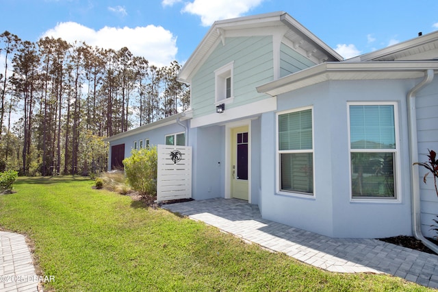 802 Margaritaville Ave, Daytona Beach, FL 32124 - view of front of house featuring stucco siding and a front yard