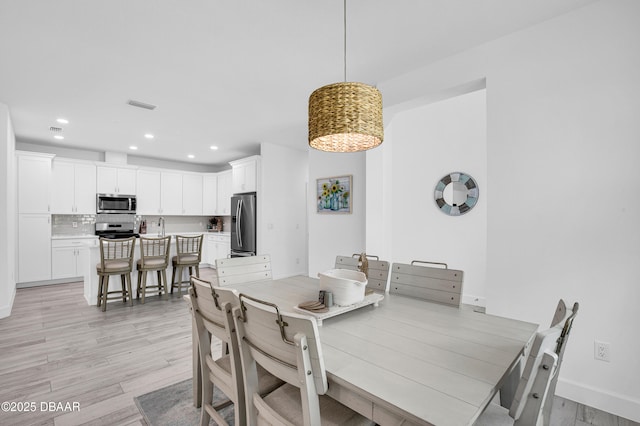 802 Margaritaville Ave, Daytona Beach, FL 32124 - dining area with light wood finished floors, recessed lighting, and baseboards