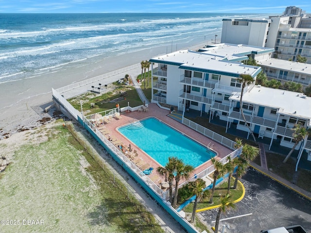 bird's eye view featuring a water view and a beach view