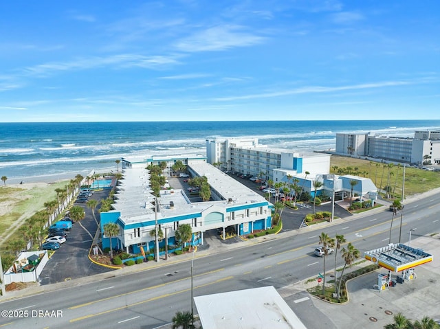 birds eye view of property featuring a beach view and a water view