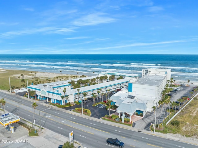 birds eye view of property with a view of the beach and a water view