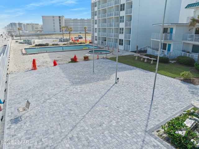 view of home's community featuring a pool and a city view