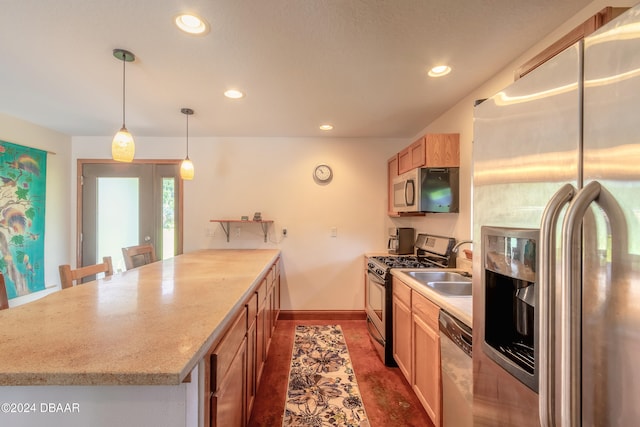 kitchen with stainless steel appliances, pendant lighting, light brown cabinets, sink, and a breakfast bar