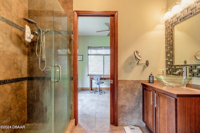 bathroom with vanity, ceiling fan, tile patterned floors, and a shower with shower door