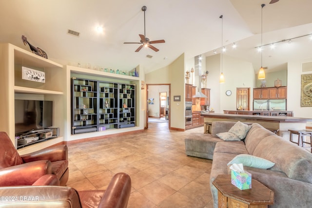 living room with high vaulted ceiling, ceiling fan, track lighting, and light tile patterned floors