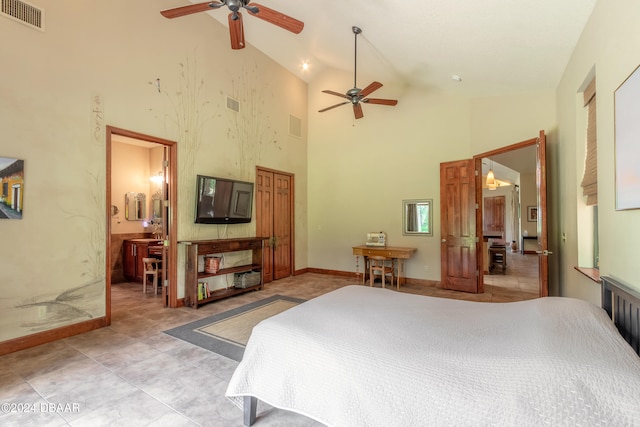 tiled bedroom featuring ensuite bathroom and high vaulted ceiling