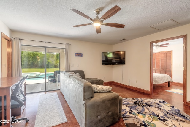 living room featuring a textured ceiling and ceiling fan