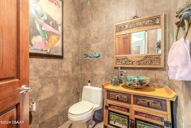 bathroom with tile walls, sink, and toilet