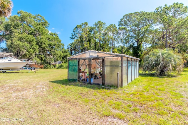 view of outbuilding with a lawn