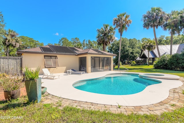 view of pool featuring a sunroom and a patio area