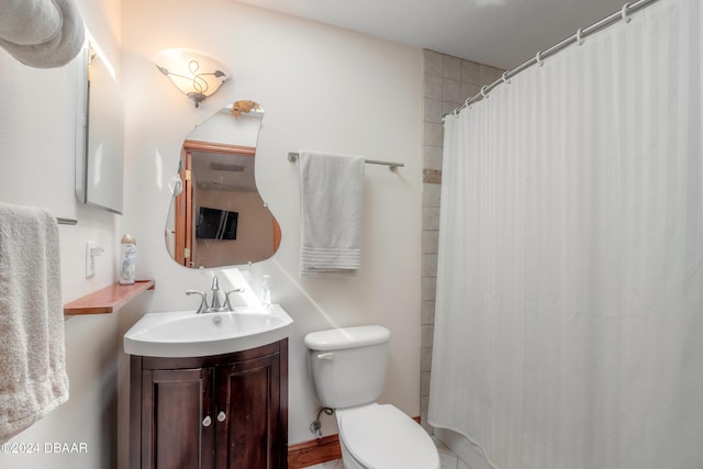 bathroom featuring walk in shower, vanity, and toilet