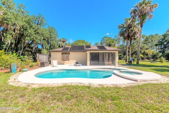 view of swimming pool with a patio, a sunroom, an in ground hot tub, and a yard