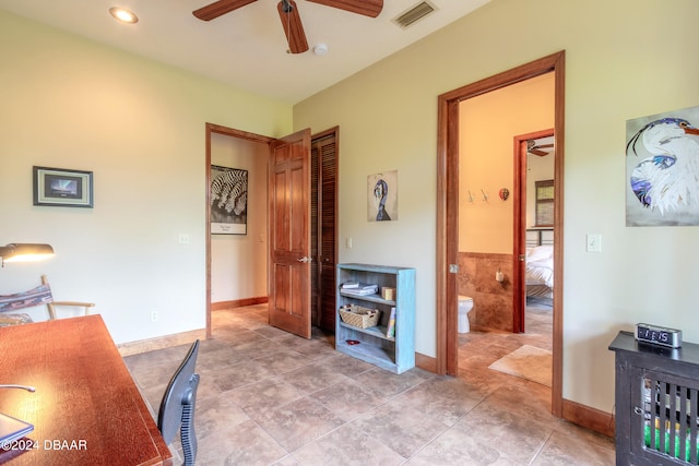 tiled home office featuring ceiling fan