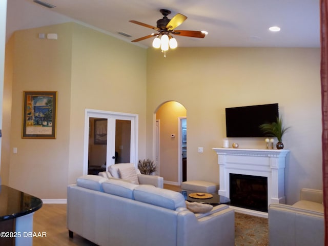 living room featuring ceiling fan, high vaulted ceiling, and hardwood / wood-style flooring