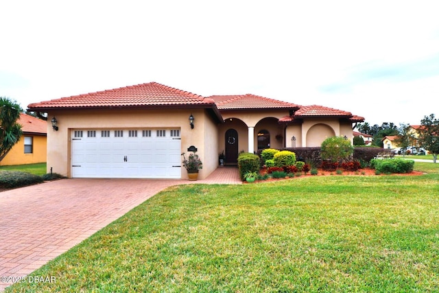 mediterranean / spanish house with a garage and a front yard